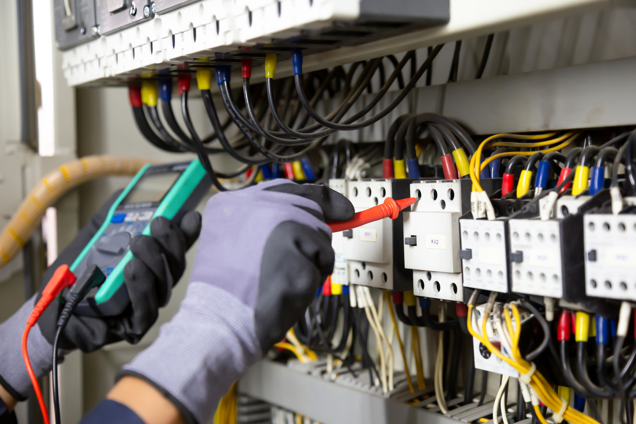 Electrician inspecting a breaker panel during consultation